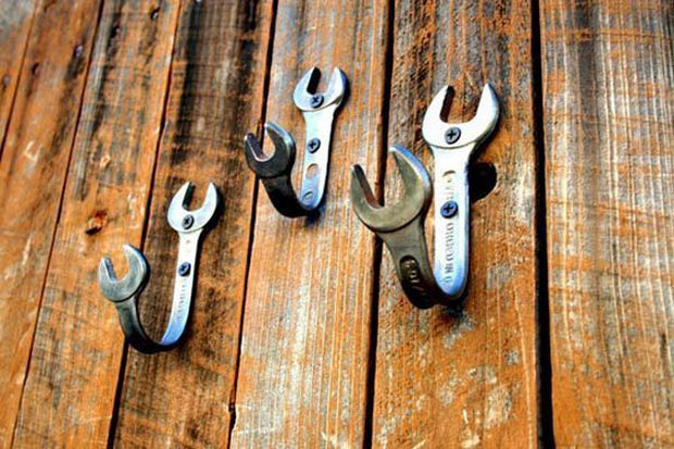 Bend old wrenches into wall hooks.