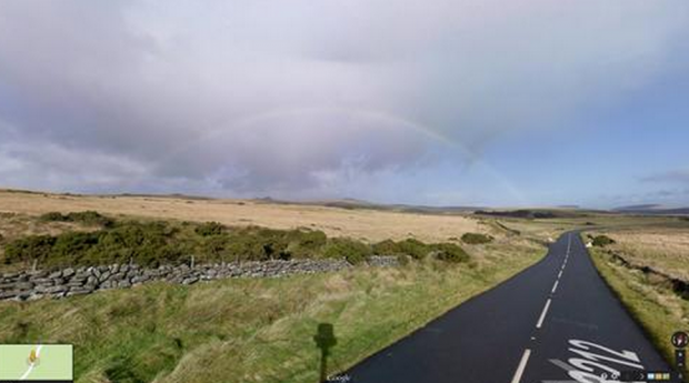 A rainbow starting to develop in the distance.