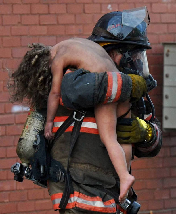 29 Powerful Pictures - Captain Donald Spindler saves 6-year-old Aaliyah Frazier from a fire in Indiana.