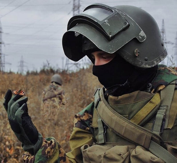 29 Powerful Pictures - A Russian special troops soldier admiring a butterfly on his finger.