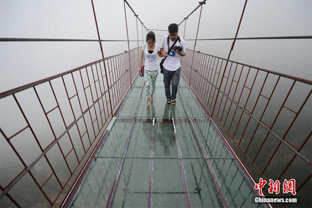 Glass Bridge in China - What makes it even more terrifying is that unlike the glass path on Tianmen Mountain, this bridge is suspended so it also moves in the wind.