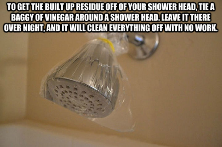52 Cleaning and Life Hacks - To get the built up residue of your shower head, tie a baggy of vinegar around a shower head.