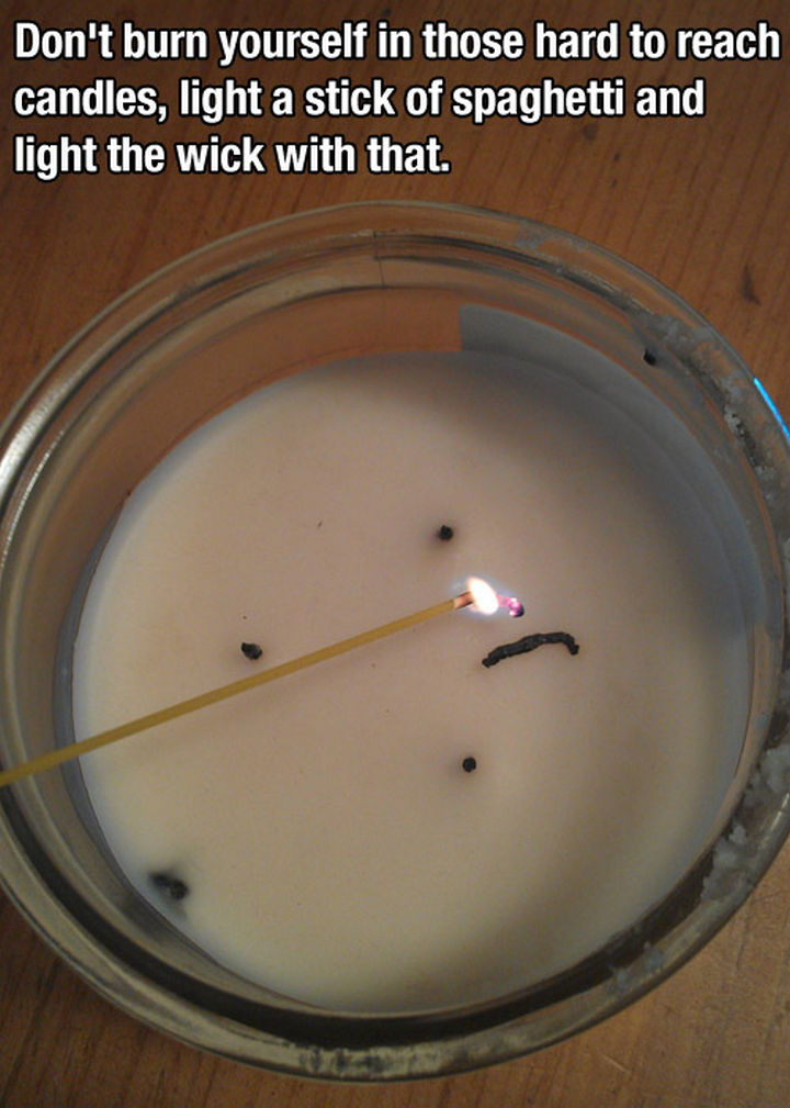 52 Cleaning and Life Hacks - Don't burn yourself with those hard to reach candles. Light a stick of spaghetti and light the wick with that.