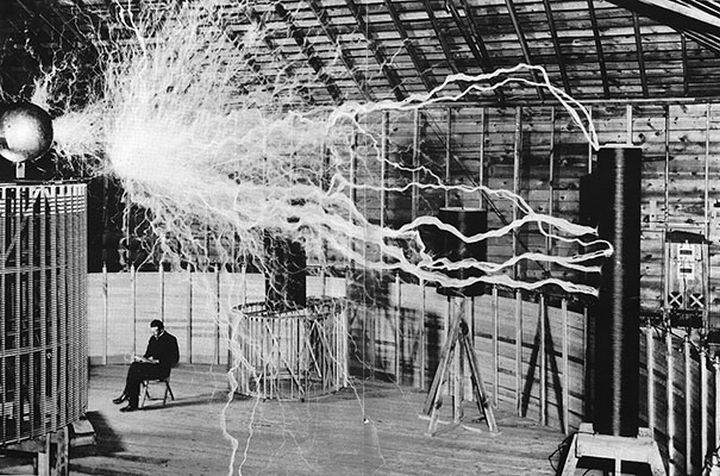 21 Historical Photos - Nikola Tesla, electrical engineering pioneer, sitting in his laboratory with his "Magnifying Transmitter".