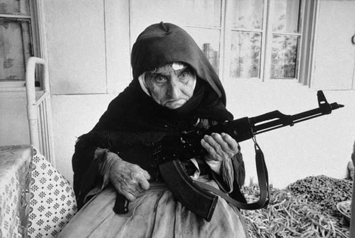 21 Historical Photos - 106-year-old woman guards her home with a rifle, in Degh village, near the city of Goris in southern Armenia, 1990.