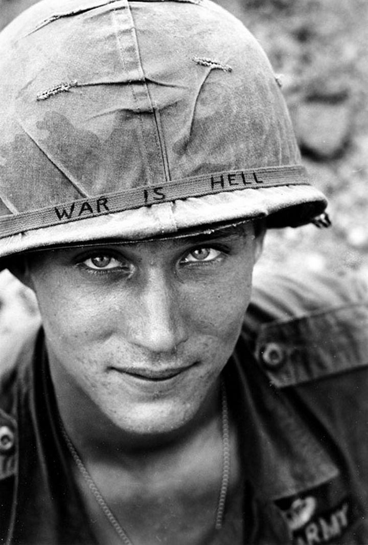 21 Historical Photos - Unidentified US Army soldier wearing a hand-lettered"War Is Hell" slogan on his helmet, 1965.