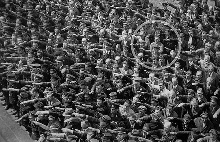 21 Historical Photos - A lone man refusing to do the Nazi salute, 1936.
