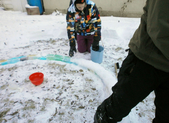 Using a mixture of snow and water to bind the bricks together.