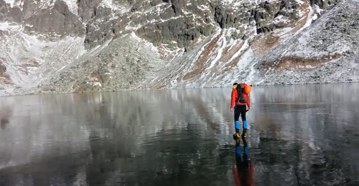 Hikers Walking on Crystal Clear Ice in the High Tatras Mountains.