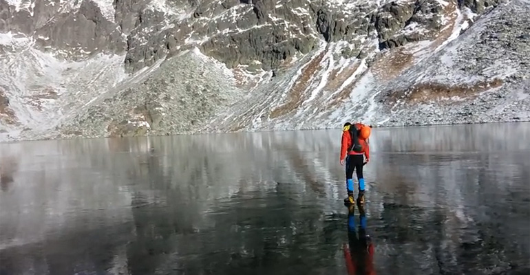 Hikers Walking on Crystal Clear Ice in the High Tatras Mountains