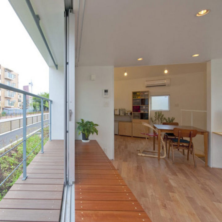 Small House Design in Japan - There are huge sliding windows in the living area that provide access to a small patio.