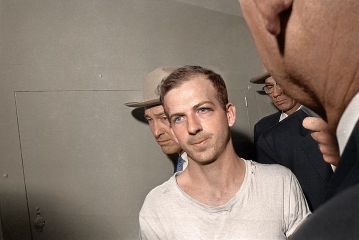 58 Colorized Photos from the Past - Lee Harvey Oswald being led down the Dallas Police Headquarter's basement for questioning on November 23rd, 1963.