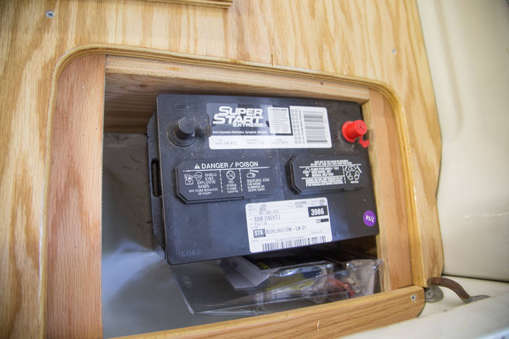The first battery is installed on the right side compartment.