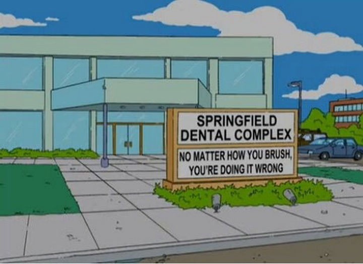 31 Funny Simpsons Signs - "Springfield Dental Complex - No matter how you brush, you're doing it wrong."