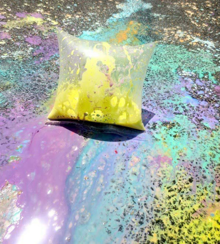 36 Summer Activities for Kids That Cost Less Than $10 - Unleash their creativity with exploding paint bags and turn your sidewalk or driveway into a work of art.
