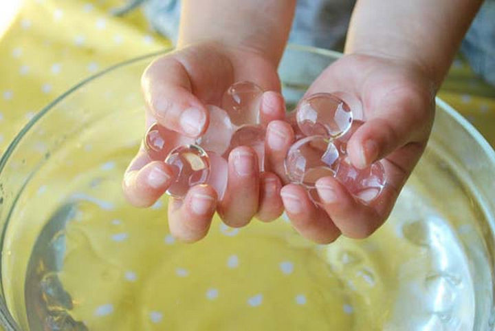 36 Summer Activities for Kids That Cost Less Than $10 - Keep them mesmerized with water marbles.