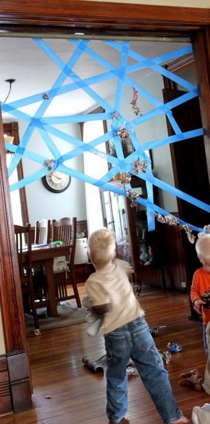 Build a sticky spider web using painter's tape.