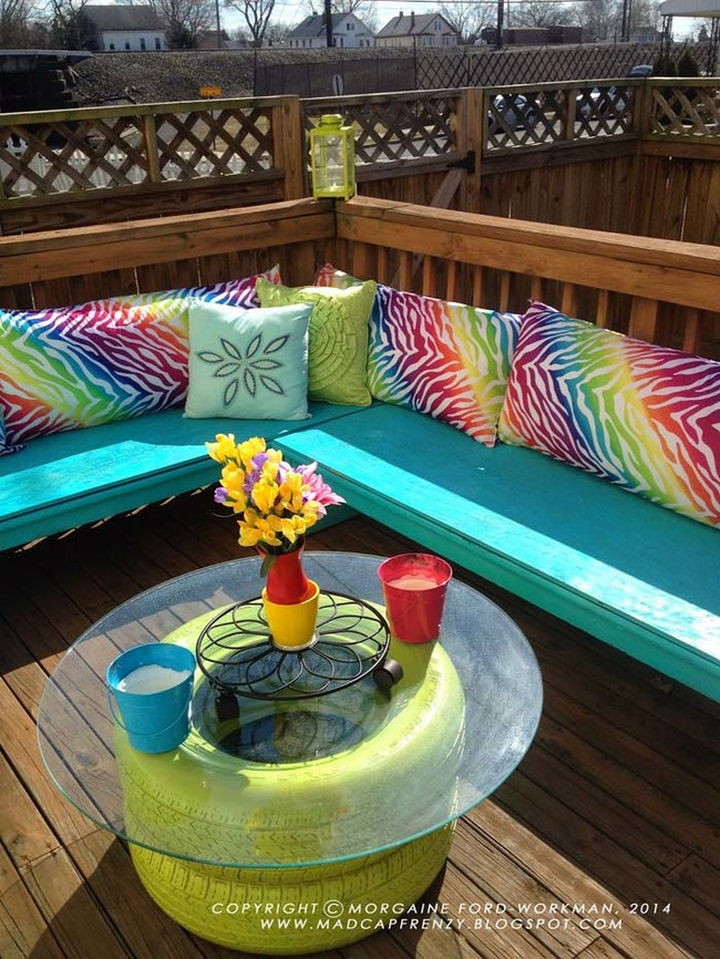 22 Awesome Ways to Turn Used Tires Into Something Great - A colorful deck seating area with matching tire coffee table.