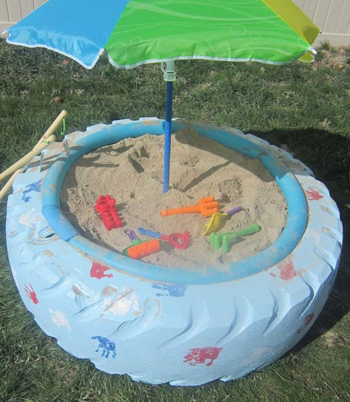 22 Awesome Ways to Turn Used Tires Into Something Great - A colorful sandbox made from a tractor tire.