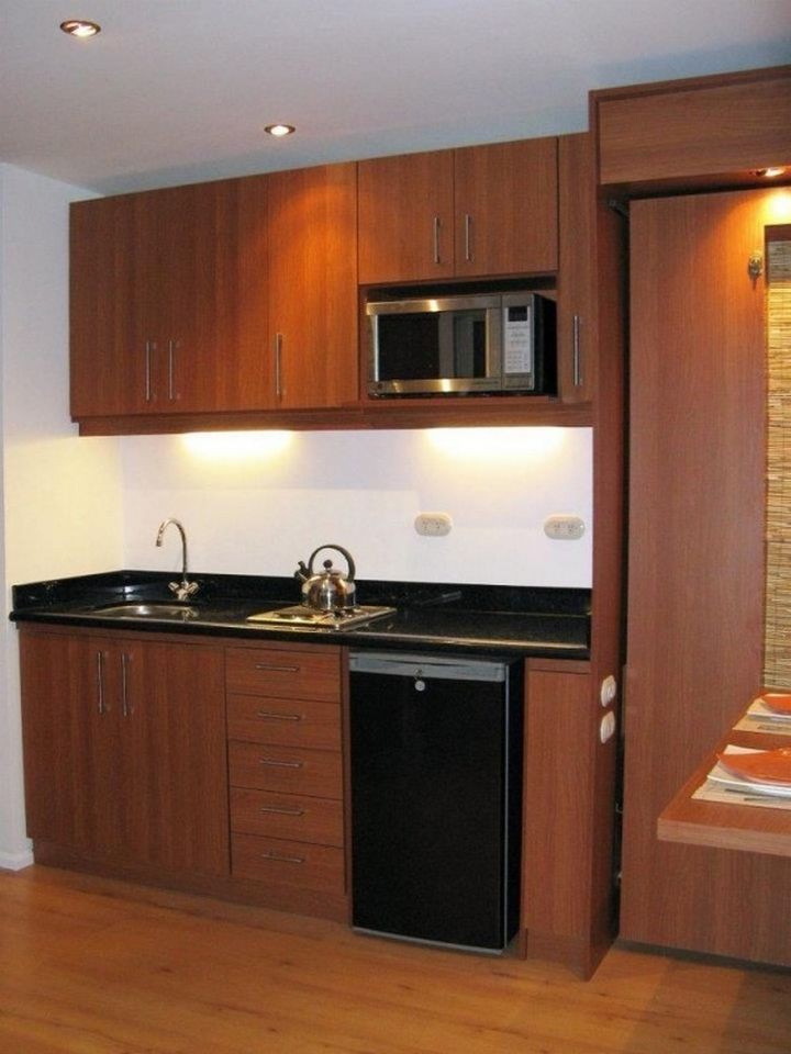 The kitchen looks great and offers a refrigerator, a two-burner stove, and space for a microwave or toaster oven.