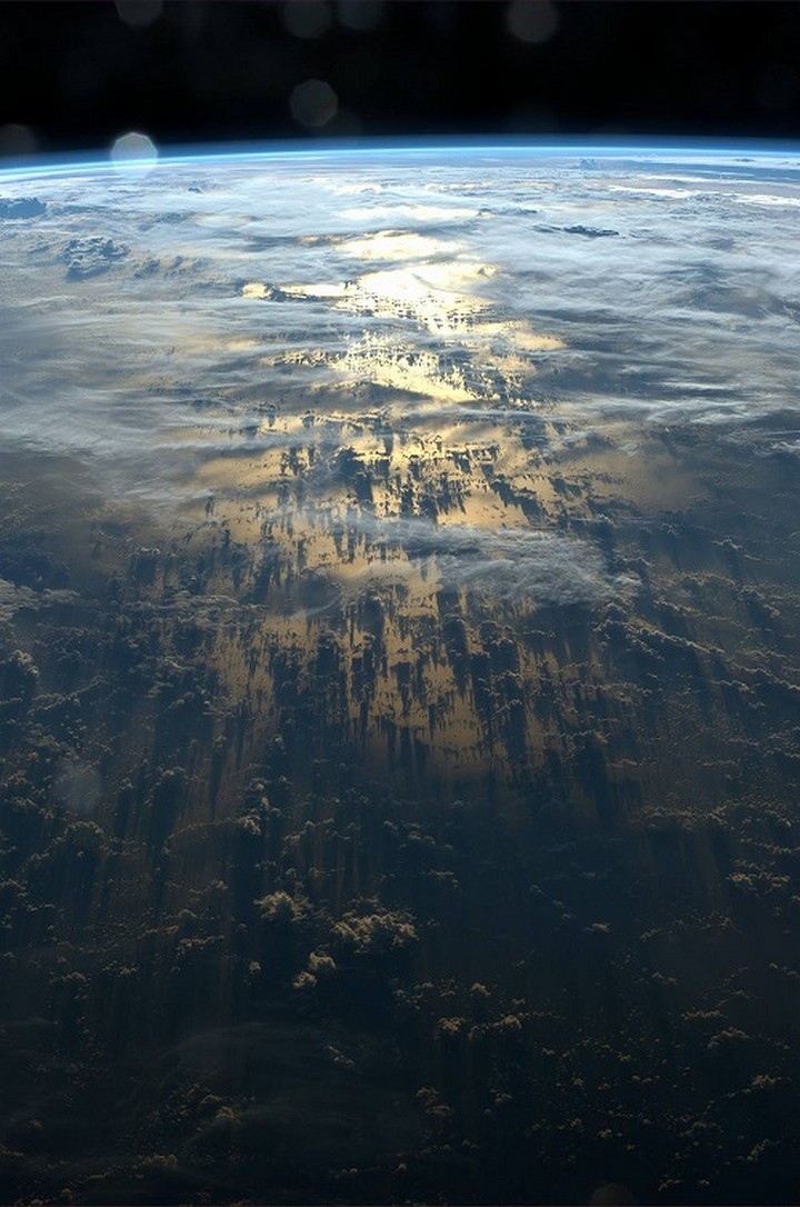 21 Awe-Inspiring Photos - Clouds casting shadows on earth as seen from the International Space Station.