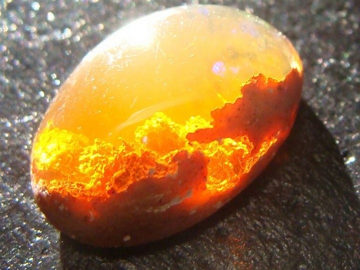 21 Awe-Inspiring Photos - An opal that looks like a sunset behind the clouds.