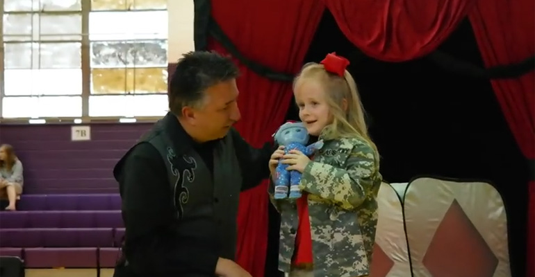 Army Soldiers Surprise Their Daughter at a School Magic Show.