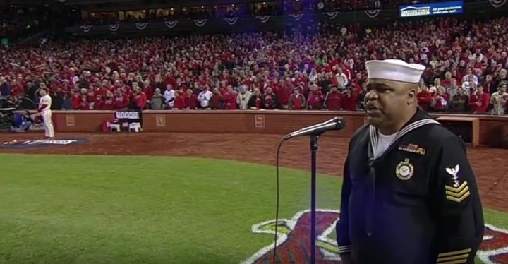 Retired Navy Officer Generald Wilson sings "God Bless America".
