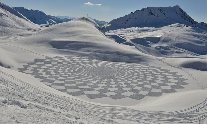 These aren't "crop circles". They are intricate pieces of art made in the snow by artist Simon Beck.