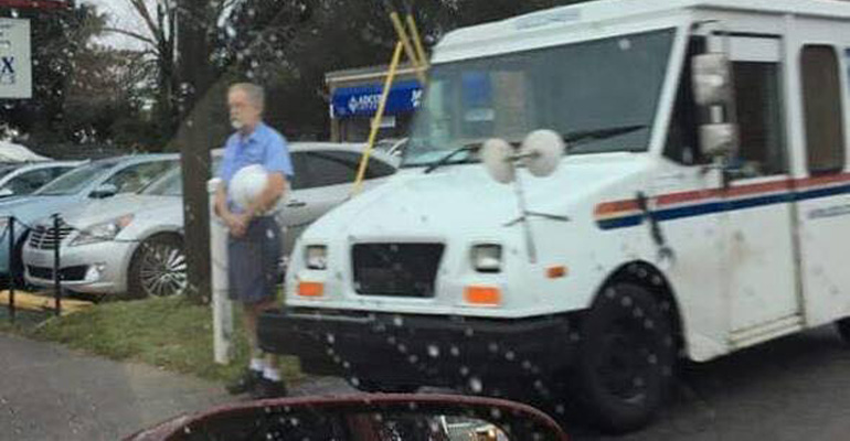 This Photo of a Postman Standing in the Rain Is Going Viral for a Very Touching Reason