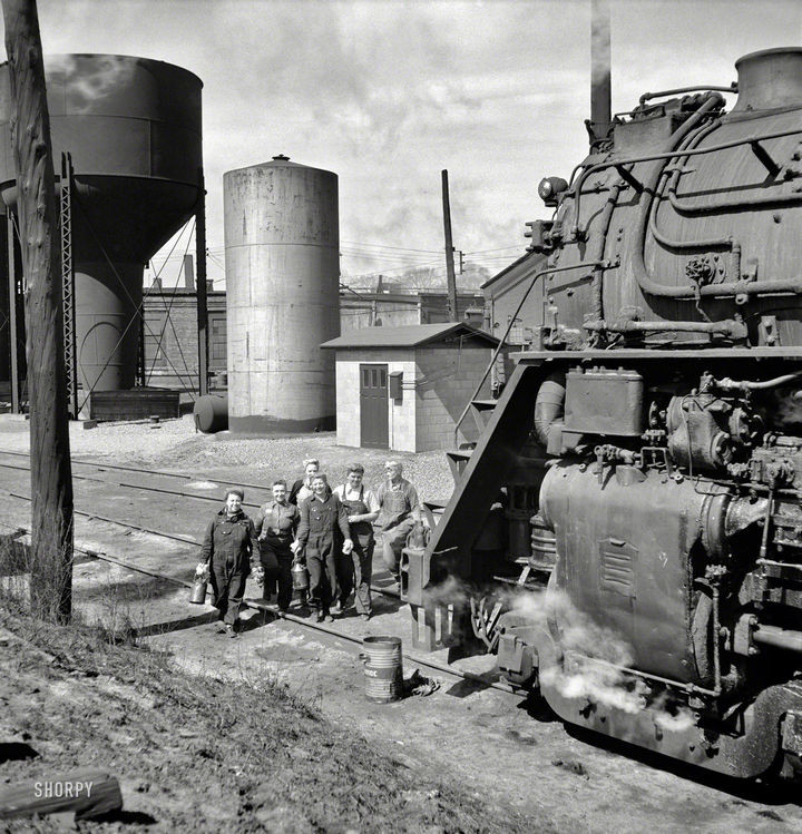 35 Rare Historical Photos - 1943: Women wipers cleaning an engine at the Chicago & North Western Railroad in Clinton, Iowa.