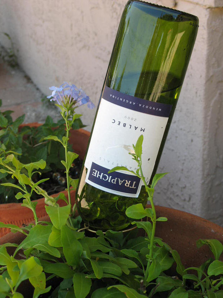 14 DIY Gardening Tips & Projects - Turn a wine bottle into a DIY self-watering bottle for your garden.
