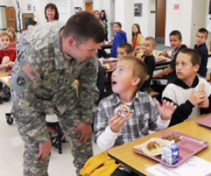 A soldier dad surprising his son at school.