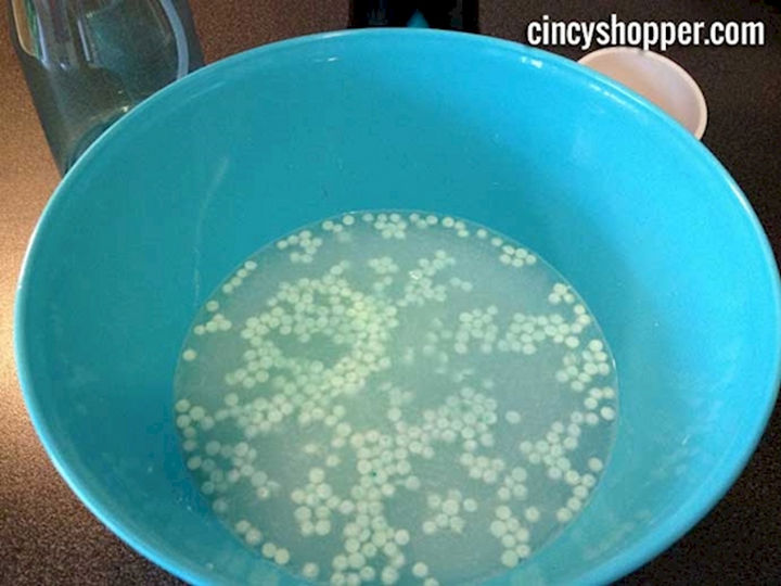 Homemade Febreze Recipe - First add the baking soda and Downy Unstoppables in a bowl of hot water.