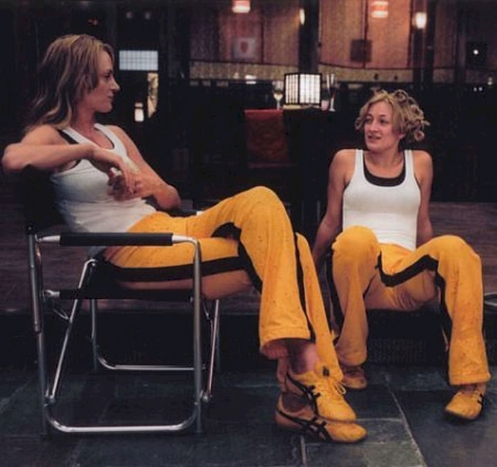 23 Celebrities Hanging Out With Their Stunt Doubles - Uma Thurman sits with her stunt double on the set of "Kill Bill: Volume 1."