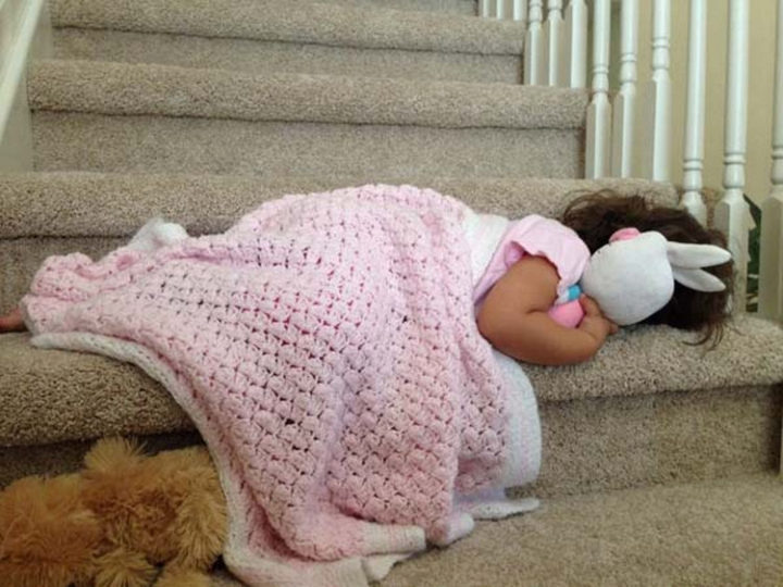 25 Kids Sleeping in the Strangest Places - She adorably couldn't make it all the way up the stairs to her bed.