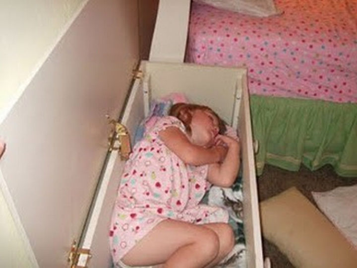 25 Kids Sleeping in the Strangest Places - A toy box makes a handy bed.