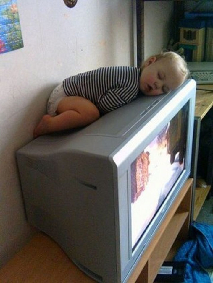 25 Kids Sleeping in the Strangest Places - Older TVs were nice and warm...perfect for a nap!