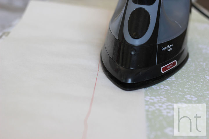 Now, use your hot iron to slowly melt the plastic together by running the iron across the line of your parchment.