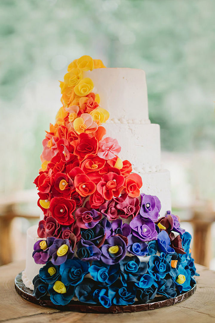 You didn't think we'd forget the cake did you? The wedding cake with colorful cascading flowers is just as breathtaking as the wedding dress.