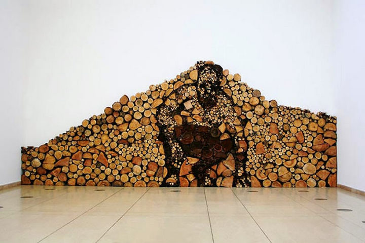 13 Displays of Stacked Wood Art - The man inside the wood pile.