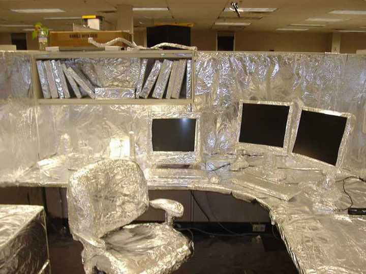 26 Funny Office Pranks - This foil covered cubicle still lets you see the monitor.