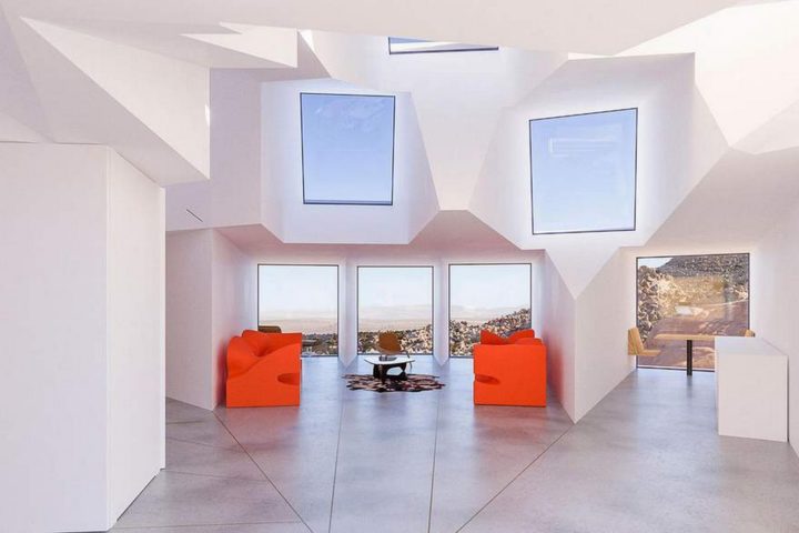 The living room features 3 southern-facing shipping containers to get a view of the desert.