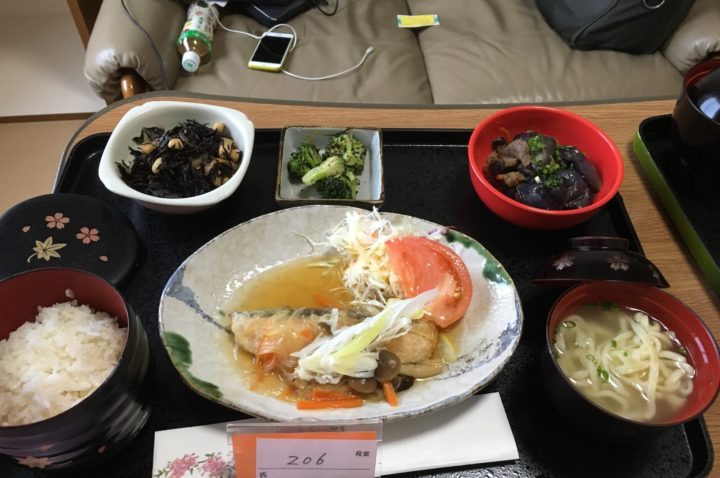 Salmon with mushroom sauce, soba noodles, rice, eggplant and beef, broccoli, and hijiki salad.
