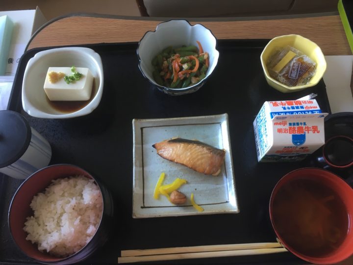 Salmon, tofu, spinach salad, natto, miso soup, rice, and milk.