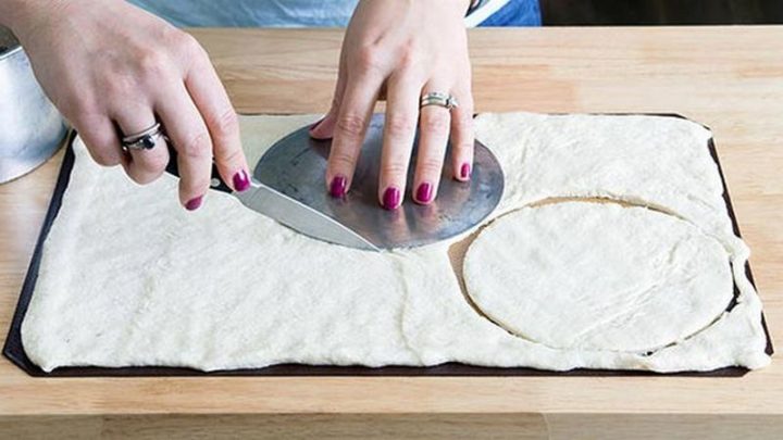 Open the first can of pizza dough and press onto cookie sheet. Cut out 3 six-inch circles and bake them on a cookie sheet at 400 degrees for 8 minutes.