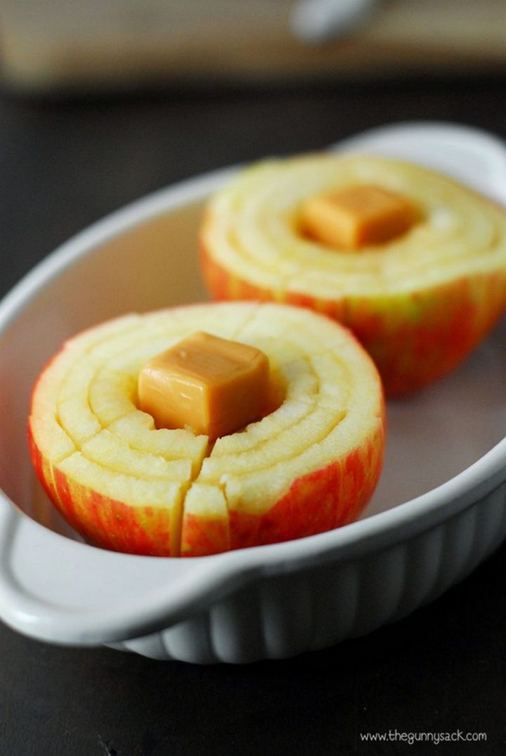 Put apples in an oven dish and drop two caramels into the center of each apple.