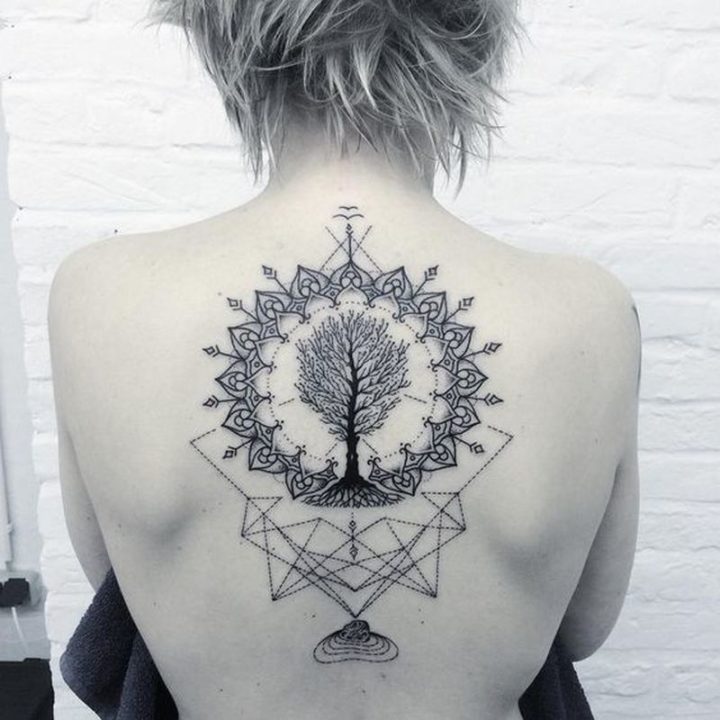 A geometric back tattoo featuring a tree.