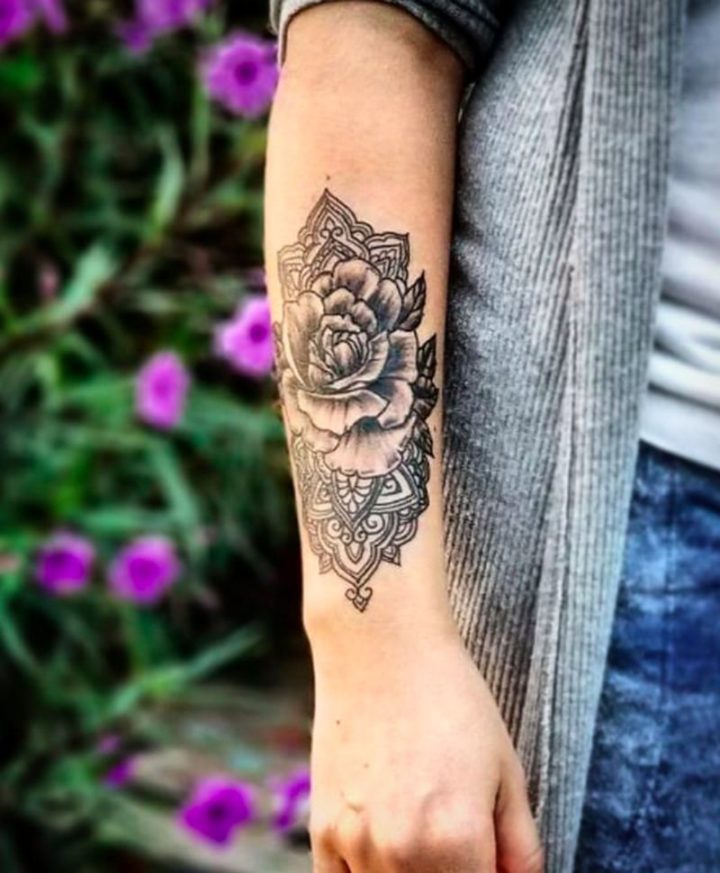 A creative arm tattoo featuring a flower print.