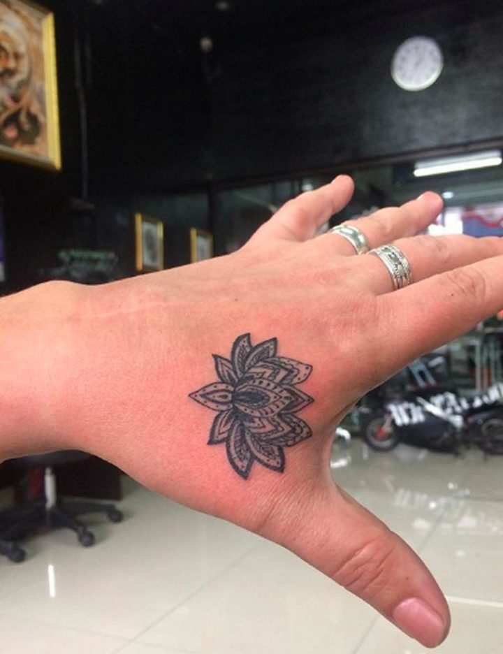 Interesting lotus mandala tattoo on the hand.